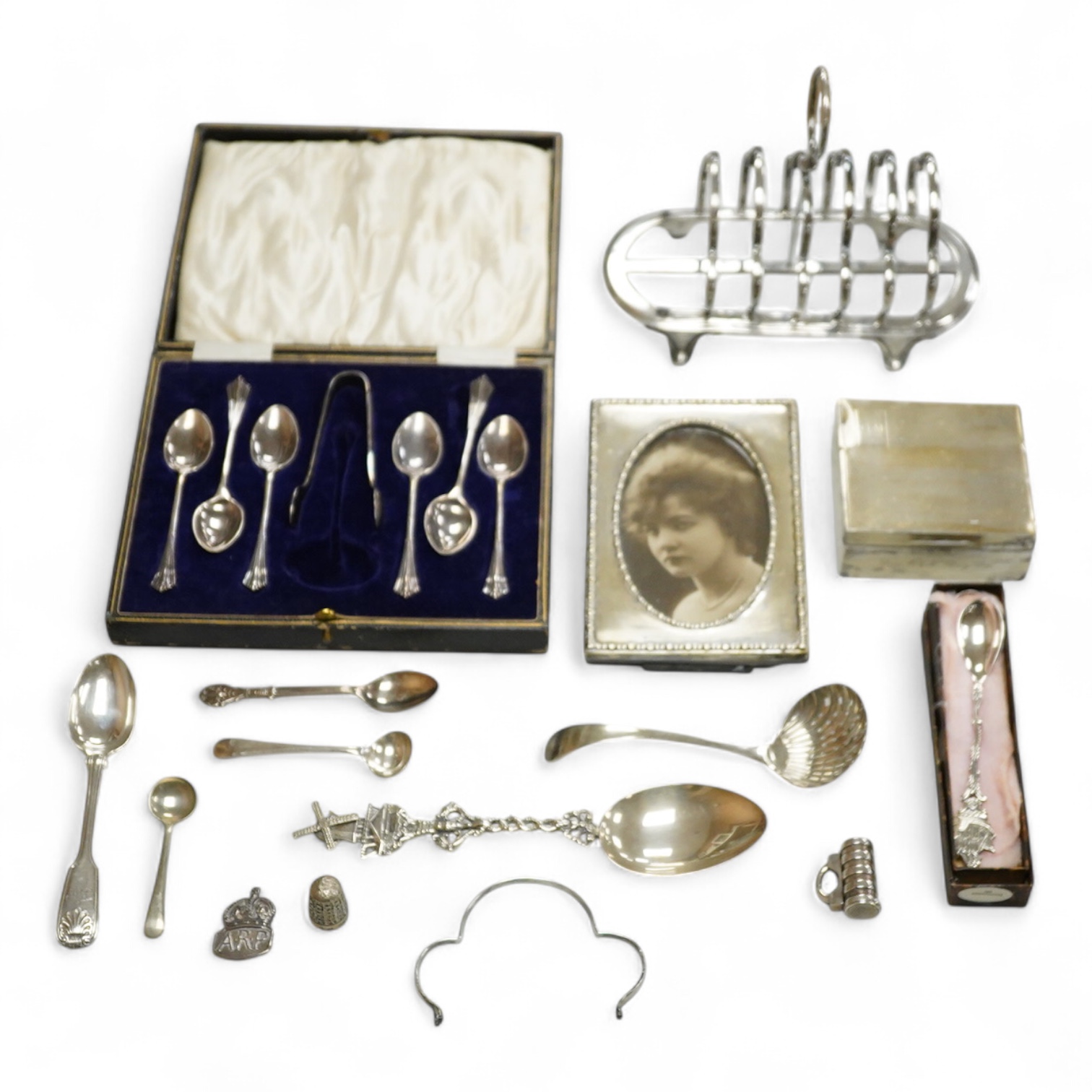 Sundry small silver including a George V mounted photograph frame, James Deakin & Sons, Sheffield, 1918, 14.8cm, a mounted cigarette box, a teaspoon, two vesta cases and thimble, together with assorted plated ware.